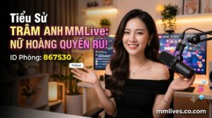Banner hồ sơ idol Trâm Anh MMLive, giới thiệu 'Nữ hoàng quyến rũ!' với ID phòng 867530. Hình ảnh một nữ streamer trẻ mỉm cười trước thiết bị livestream, với các biểu tượng trái tim và kim cương bay lên. Bao gồm domain mmlive.cn.com.